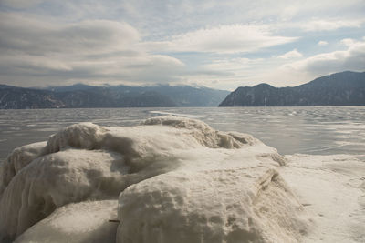 View of beautiful drawings on ice from cracks on the surface of lake teletskoye in winter, russia