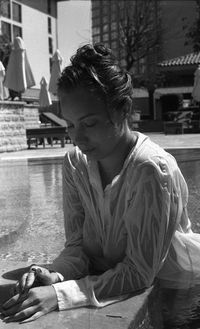 Wet woman relaxing at poolside