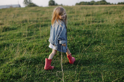 Full length of girl standing on field