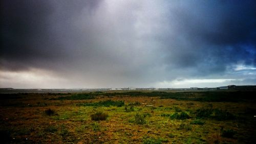 Scenic view of landscape against cloudy sky