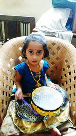 Portrait of cute girl sitting outdoors