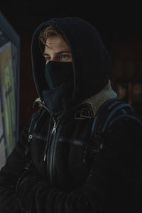 Portrait of man wearing sunglasses at night