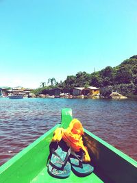 Boat in river against clear sky