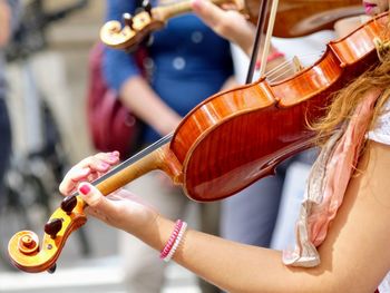 Cropped hands of woman playing violin