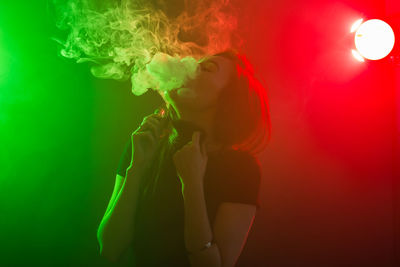 Side view of young woman smoking