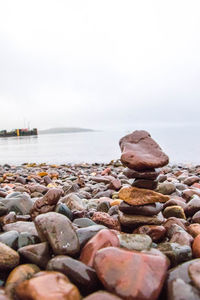 Rocks on beach against sky