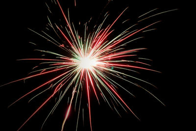 Low angle view of firework display against sky at night