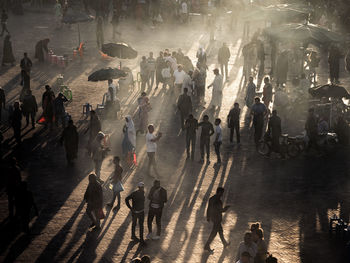 High angle view of people walking on street in city