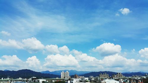 Cityscape against cloudy sky