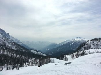 Scenic view of snow covered mountains against sky