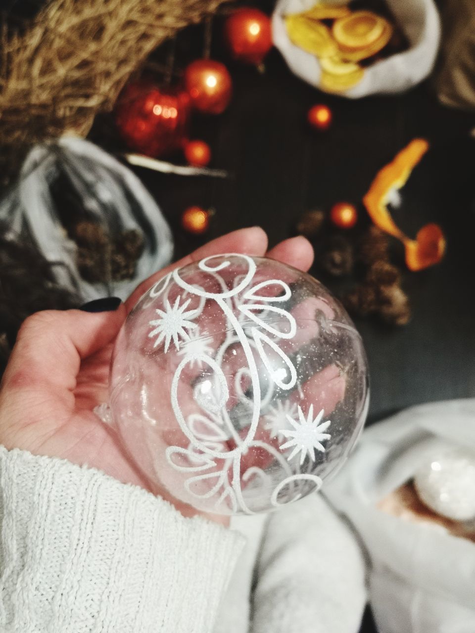 MIDSECTION OF WOMAN HOLDING CHRISTMAS DECORATION