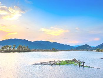 Scenic view of lake against sky during sunset