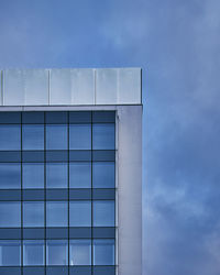 Low angle view of glass building against sky