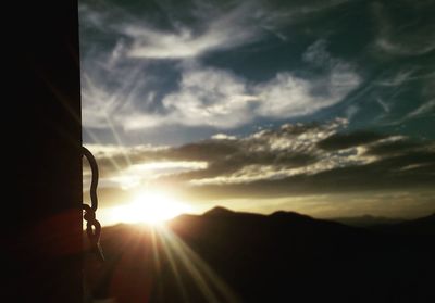 Scenic view of silhouette mountains against sky during sunset