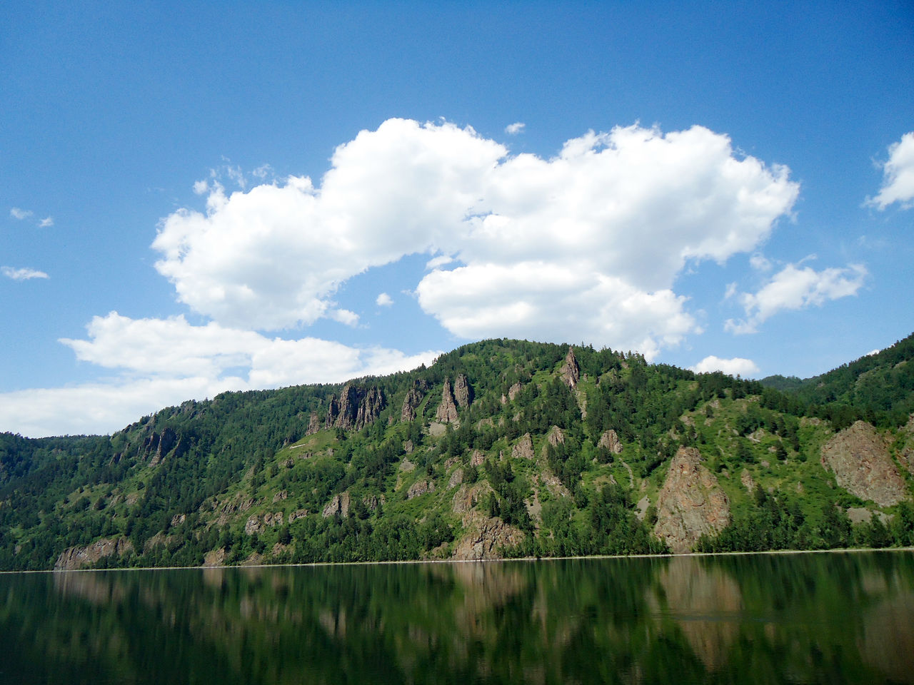 Scenic view of lake against cloudy sky