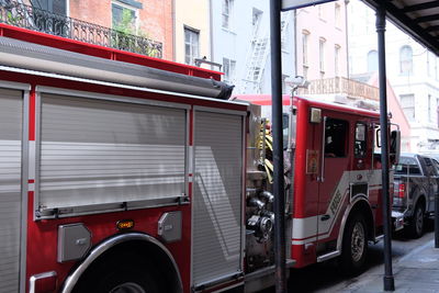 Fire truck by footpath in city