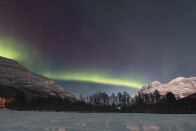 Scenic view of mountains against sky at night