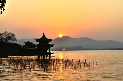 Scenic view of lake against sky during sunset