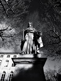 Low angle view of statue against trees