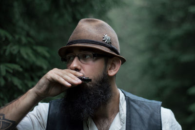 Mid adult man smoking cigarette