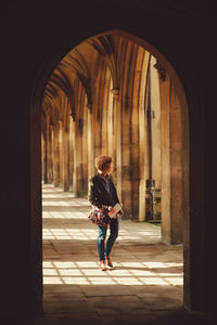 Woman standing in corridor