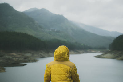 Rear view of woman looking at mountain view against sky