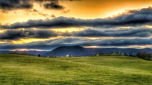 Scenic view of landscape against dramatic sky
