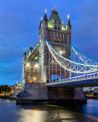 View of illuminated bridge over river