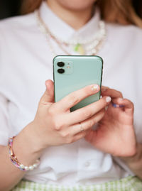 Midsection of woman using mobile phone