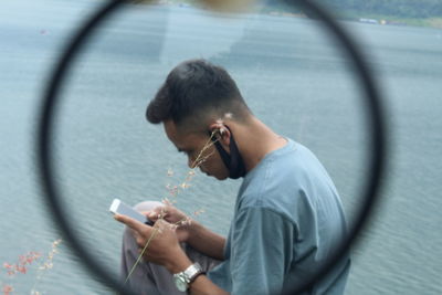 Full length portrait of man using mobile phone