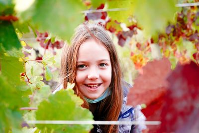 Portrait of smiling girl with leaves