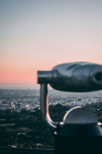 Close-up of cityscape against clear sky during sunset