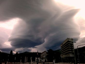 Low angle view of building against cloudy sky