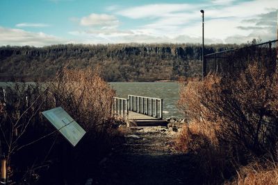 Old abandoned building on field against sky