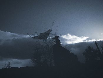 Low angle view of mountain against cloudy sky