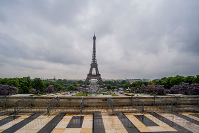 Tower of building against cloudy sky