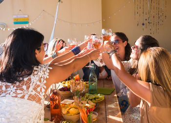 Friends toasting wineglasses in restaurant