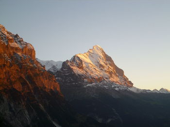 Low angle view of rocky mountains against clear sky