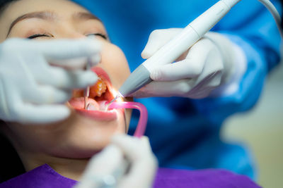 Close-up of doctor holding dental equipment