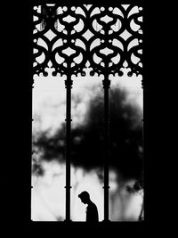 Silhouette of man against window