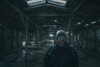 Young explorer in abandoned dark building