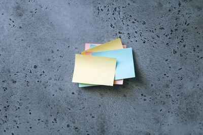 Close-up of stacked adhesive notes on wall
