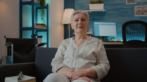 Portrait of senior woman sitting at home