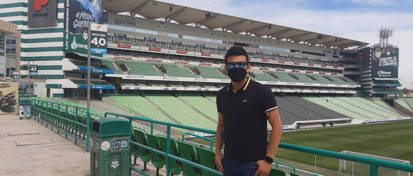 Portrait of man standing on railing