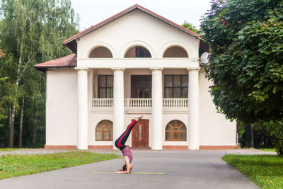 Low angle view of woman jumping on street