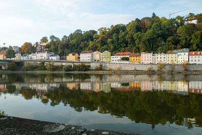 Reflection of buildings in lake against sky