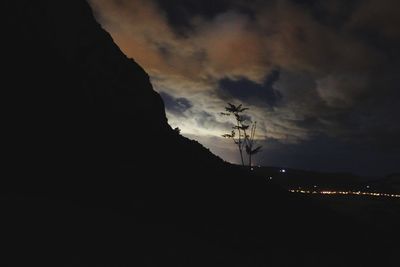 Silhouette of mountain against sky at night