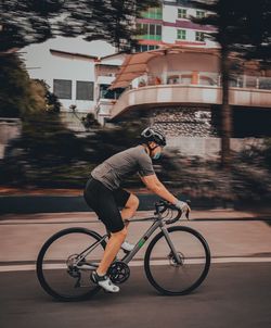 Man riding bicycle on street in city