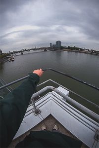 Man on boat in river against sky