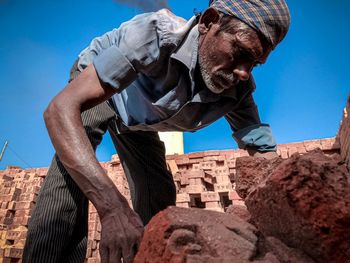 Low angle view of man standing against built structure